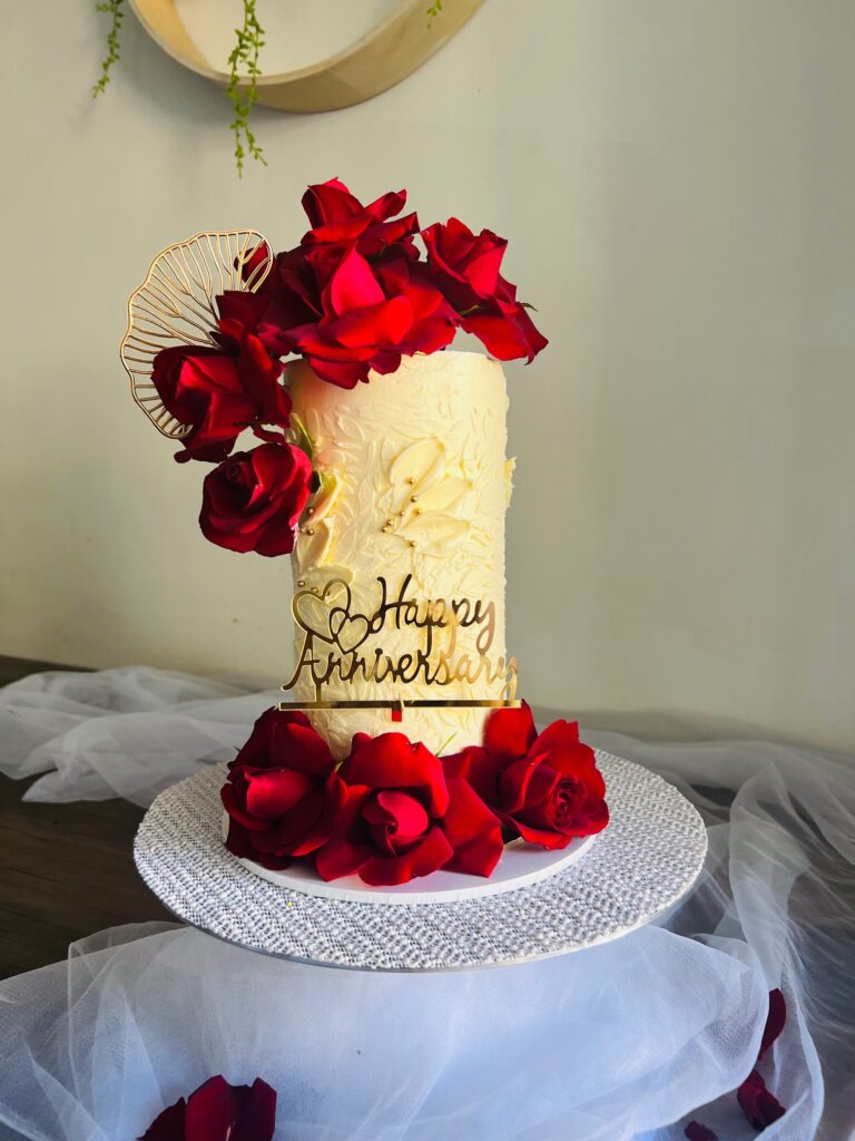 Custom anniversary cake with Syndey's finest buttercreams. Romantic chocolate ganache anniversary cake adorned with fresh red roses.